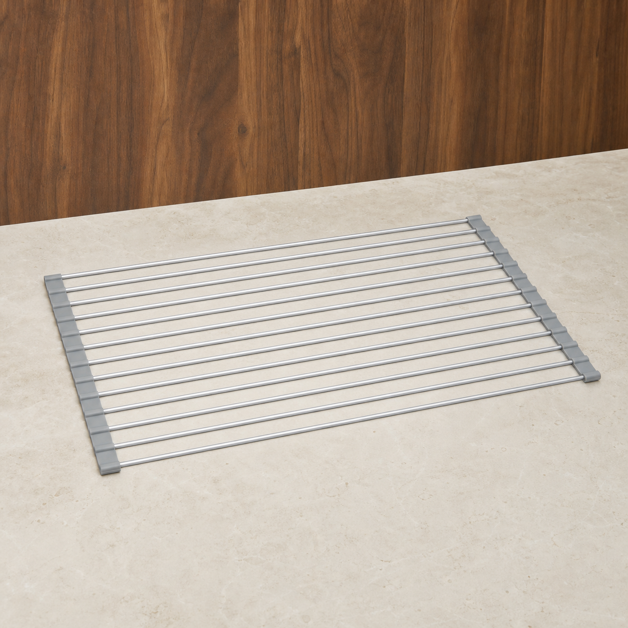 Silver roll-up sink rack fully opened in a warm studio setting