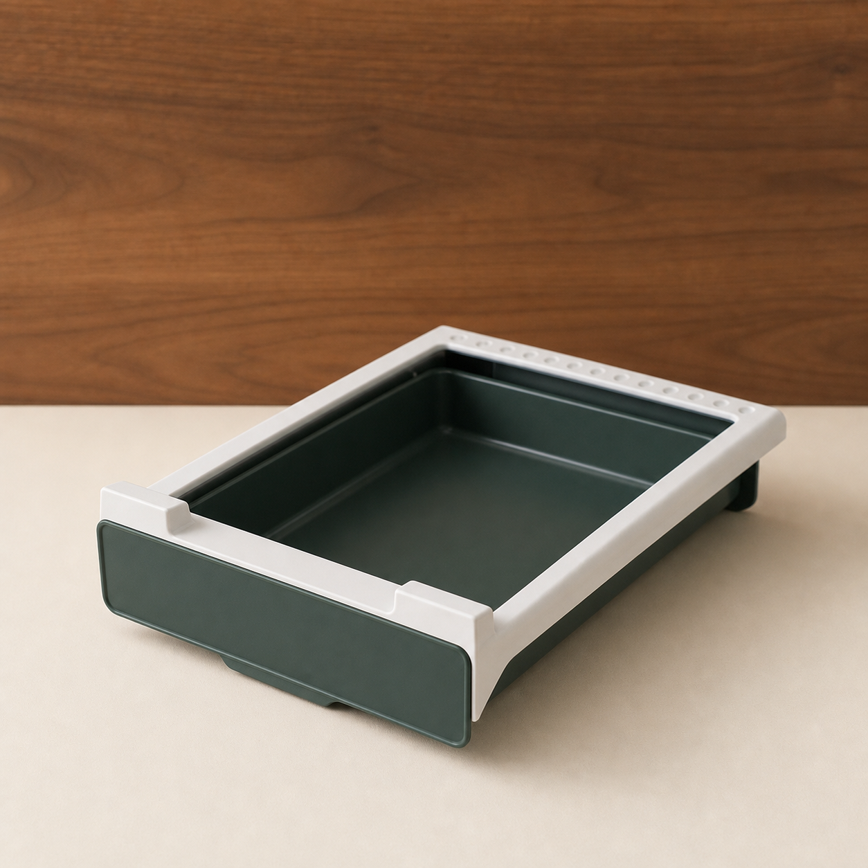 Green and white under-shelf drawer shown empty in a warm studio setting