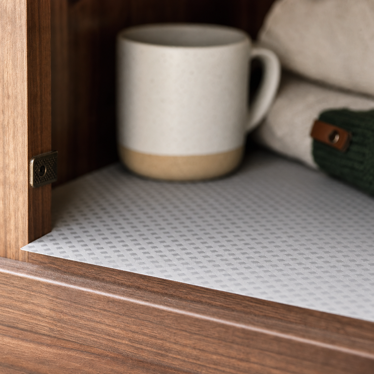 Close detail of the raised diagonal-plaid texture on a gray EVA cabinet liner