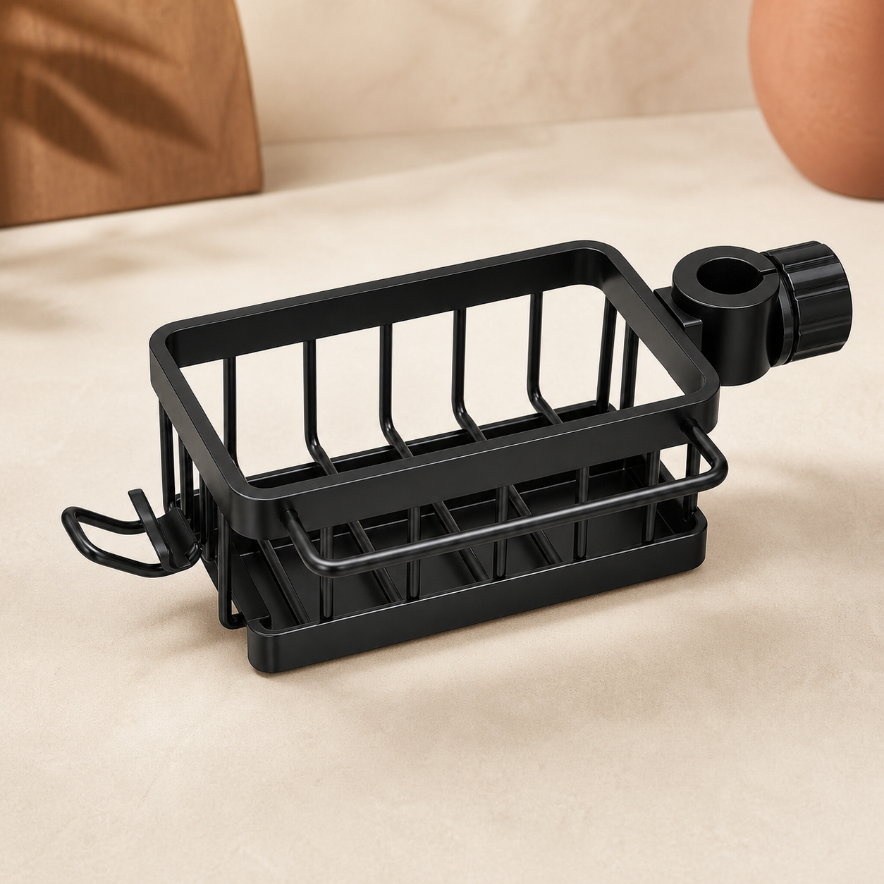 Black swing-arm sink organizer with clamp, towel rail, and hook in a warm studio setting