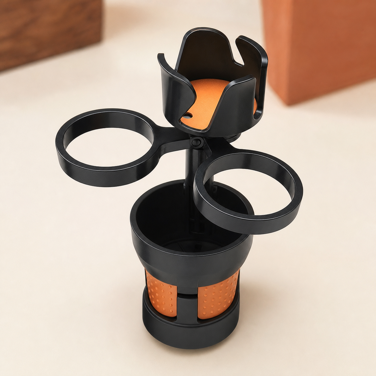 Black expandable cup station opened to show two rotating cup rings and phone cradle